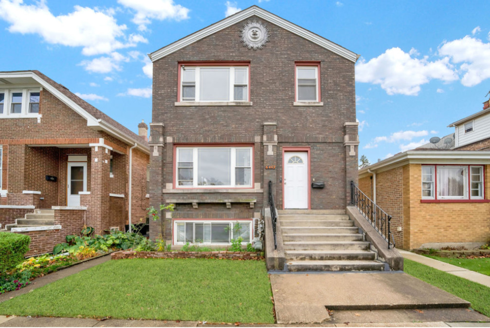 a front view of a house with garden