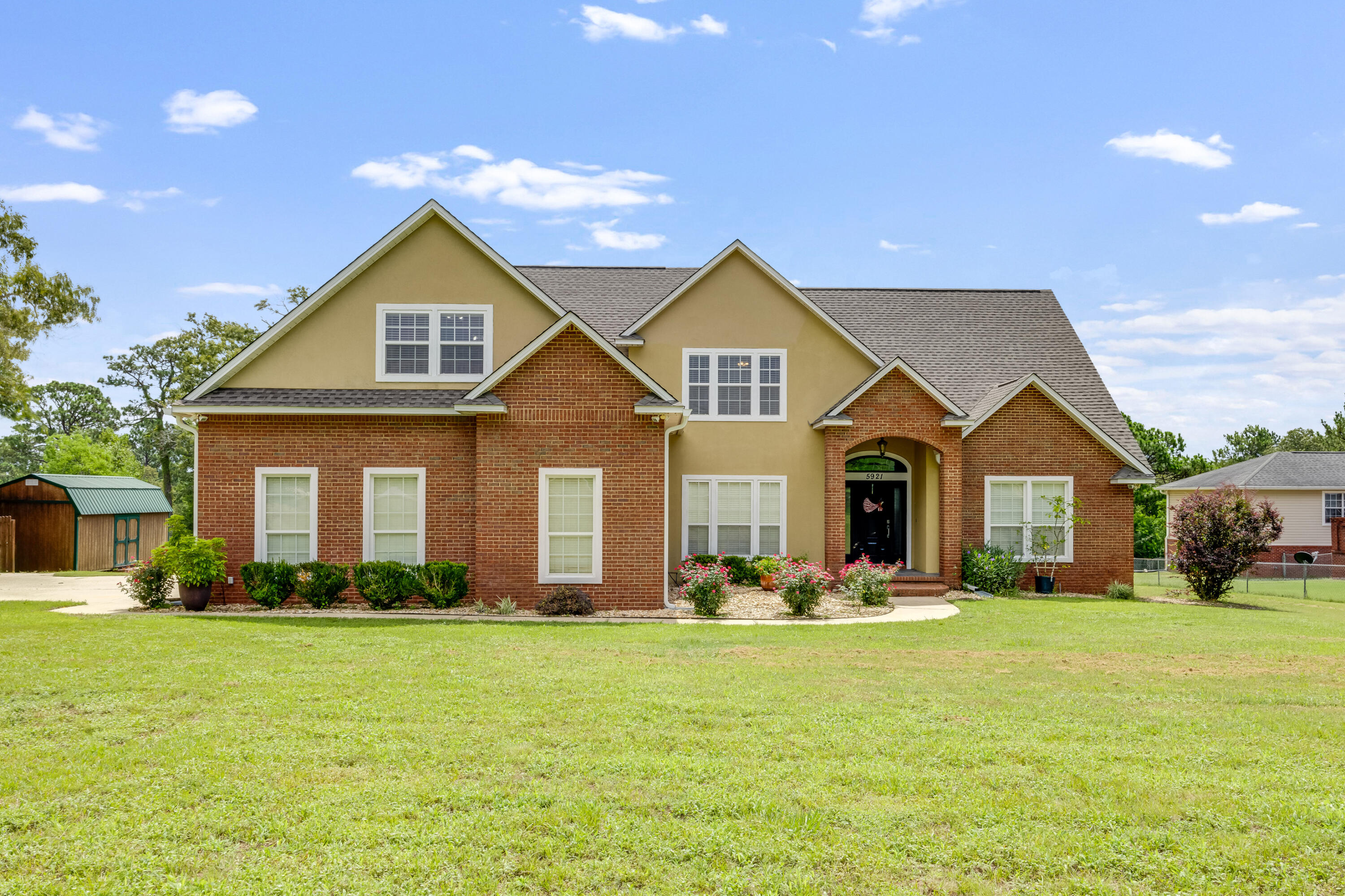 a front view of house with yard and green space