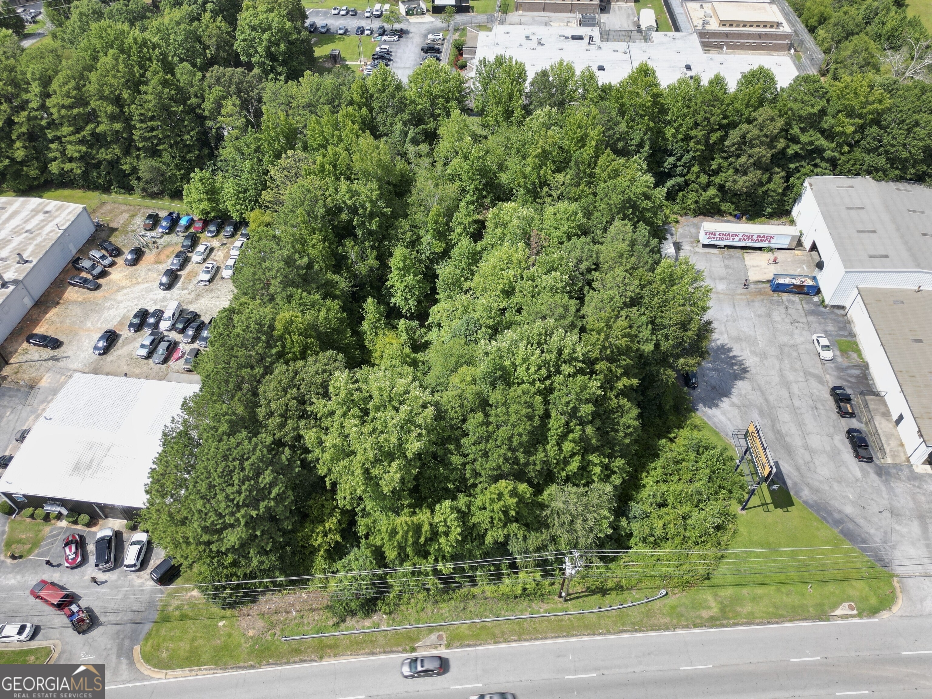 an aerial view of a house with a yard basket ball court and outdoor seating