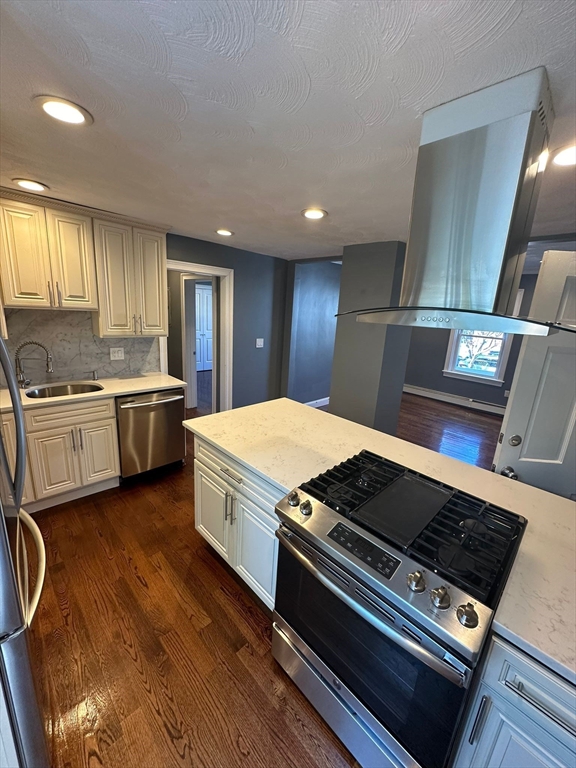 a kitchen with stove and cabinets