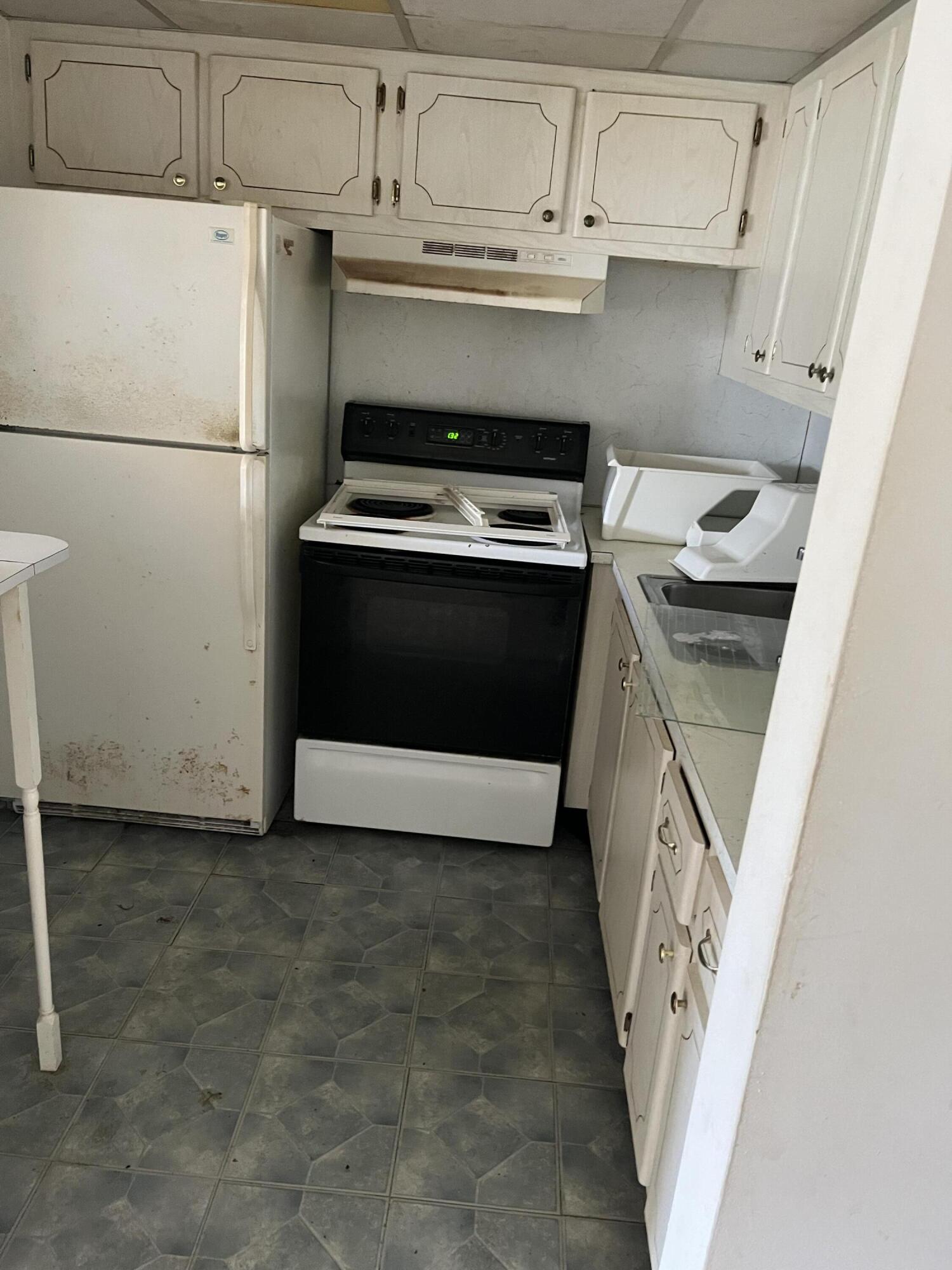 a kitchen with a stove and a refrigerator