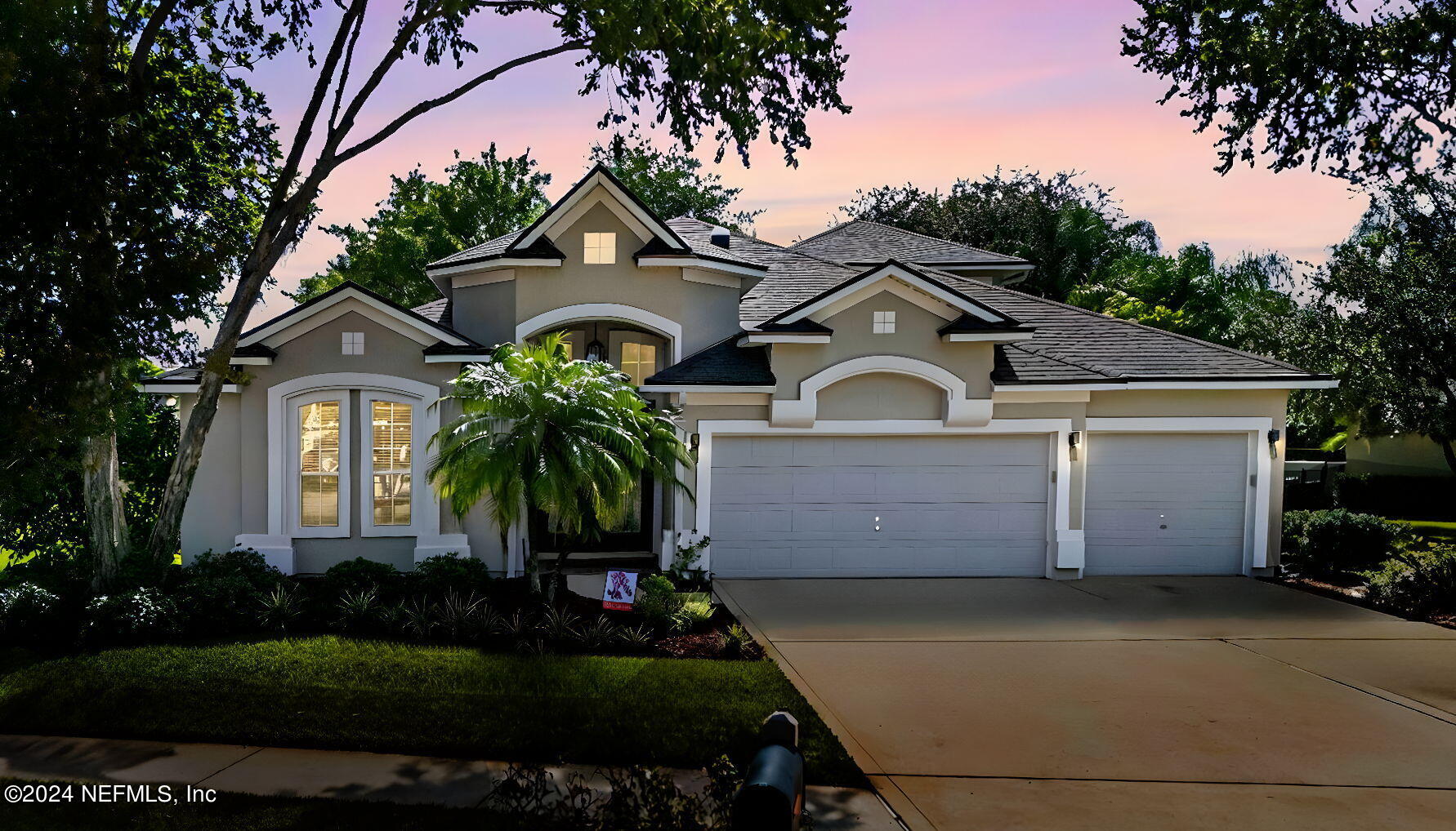 a front view of a house with a garden