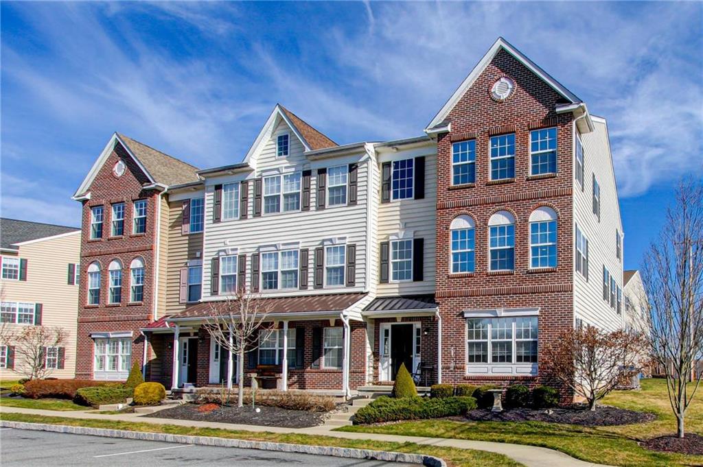 a front view of a residential apartment building with a yard