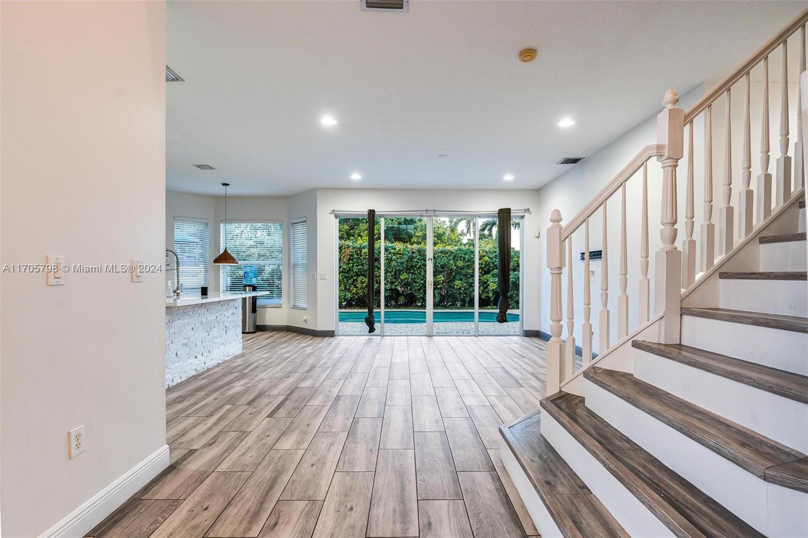 a view of wooden floor and staircase in a room