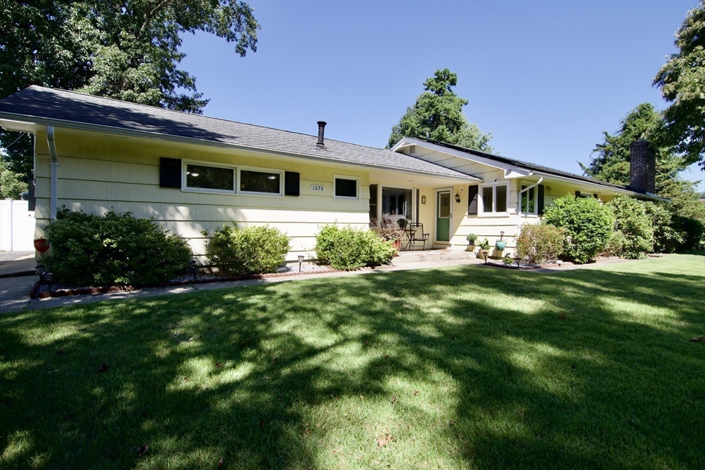 a front view of a house with garden