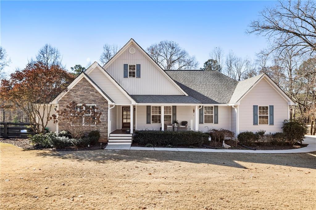 a front view of a house with a yard covered in snow