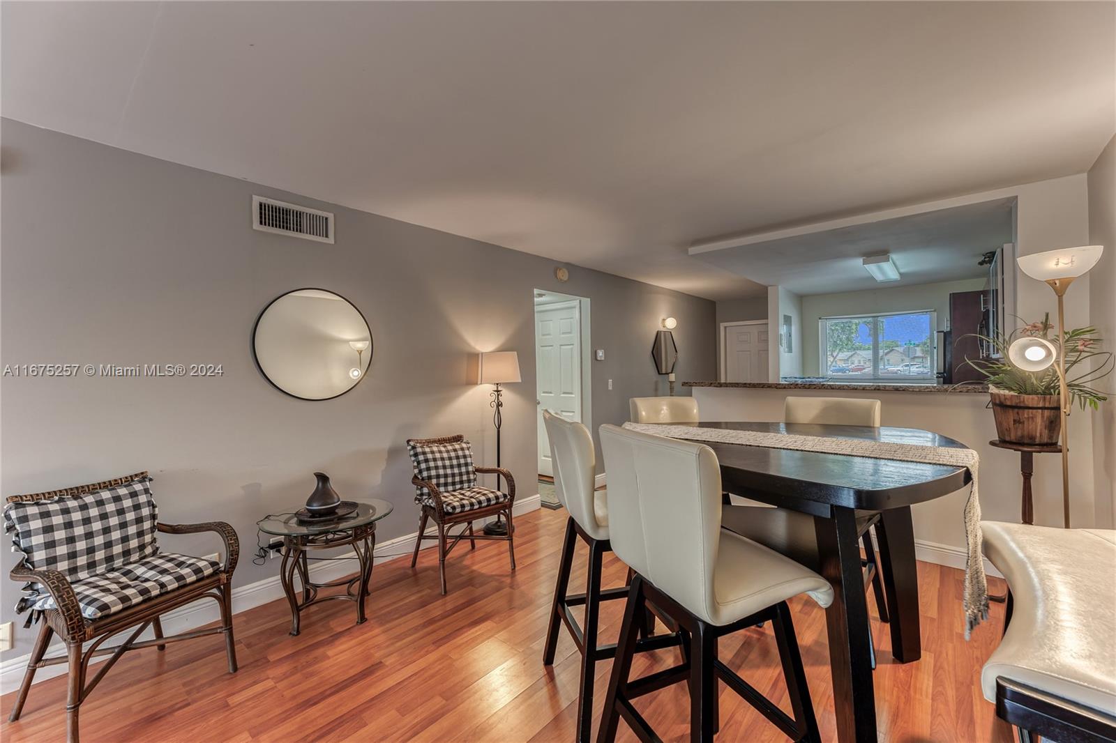 a view of a dining room with furniture and wooden floor