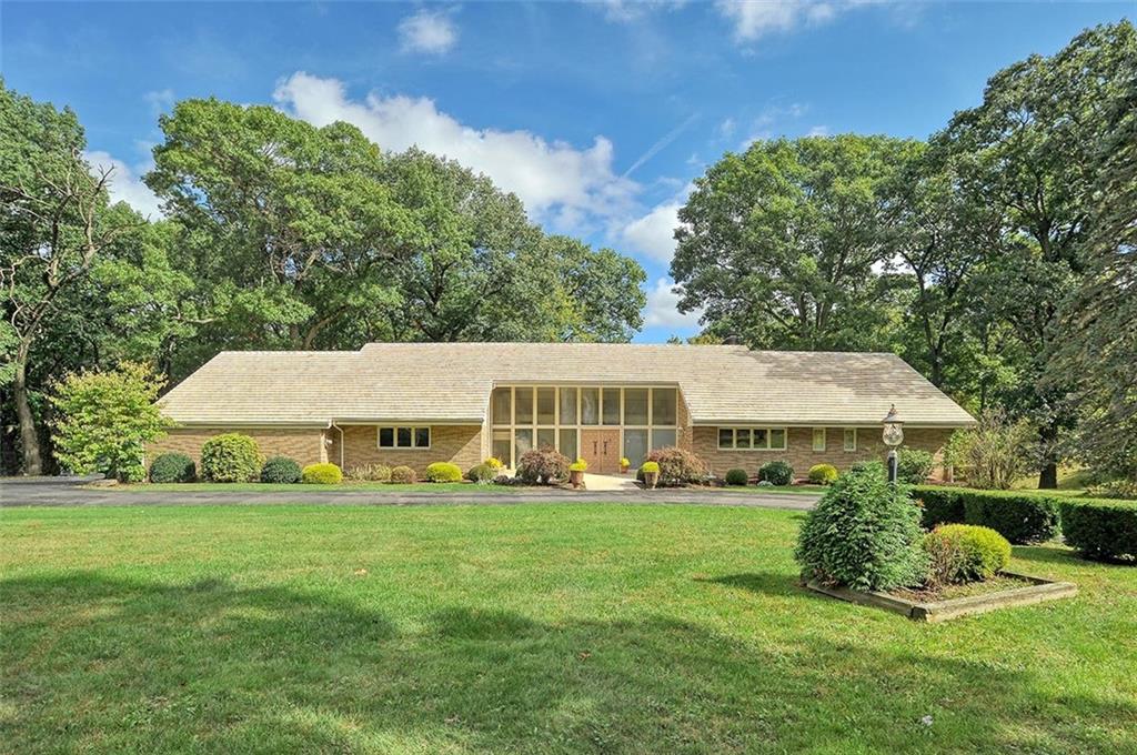 a view of a house with a yard and sitting area