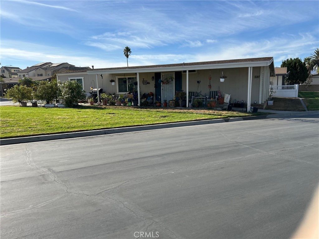 a view of a house with a yard and furniture