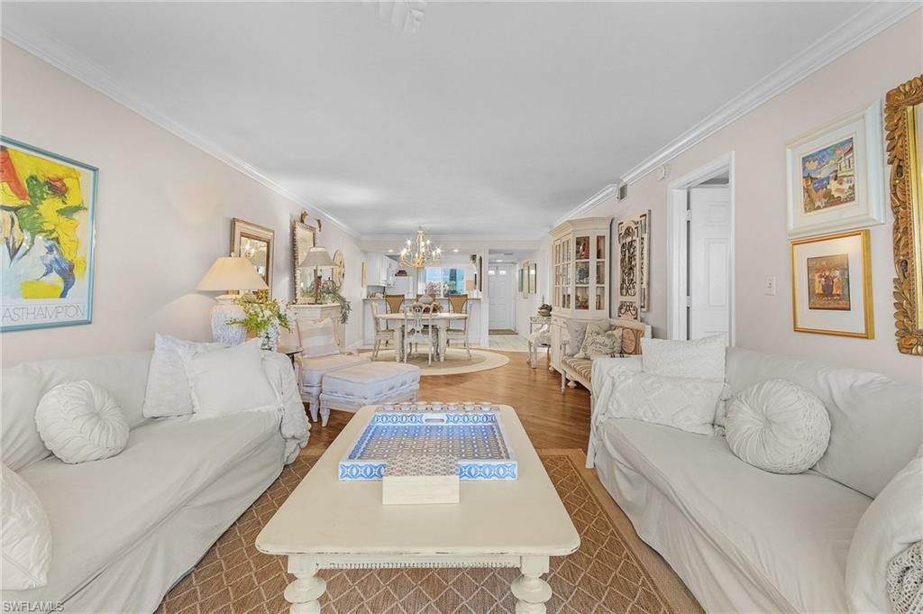 a living room with furniture and painting on the wall