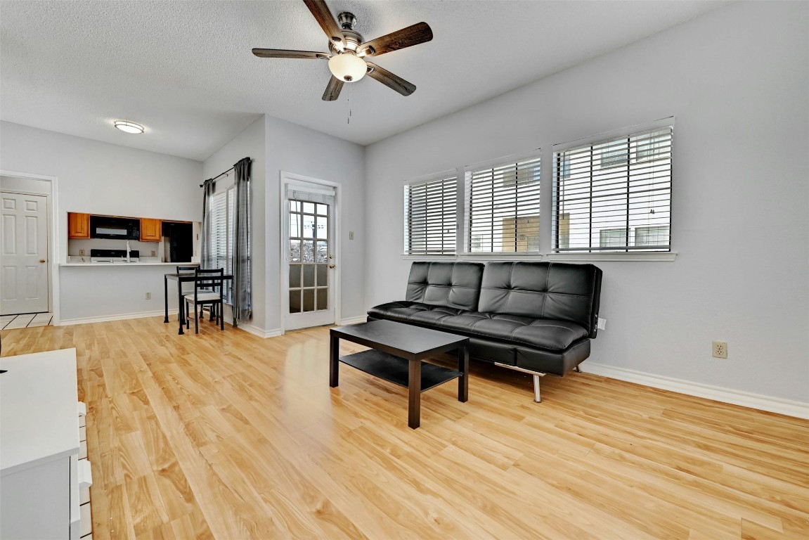 a living room with furniture and a wooden floor