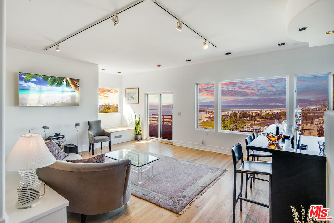 a living room with furniture and a floor to ceiling window