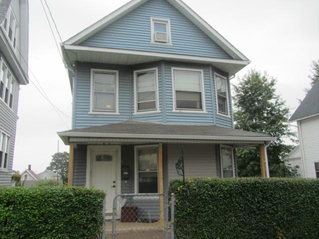 a front view of a house with plants and entryway