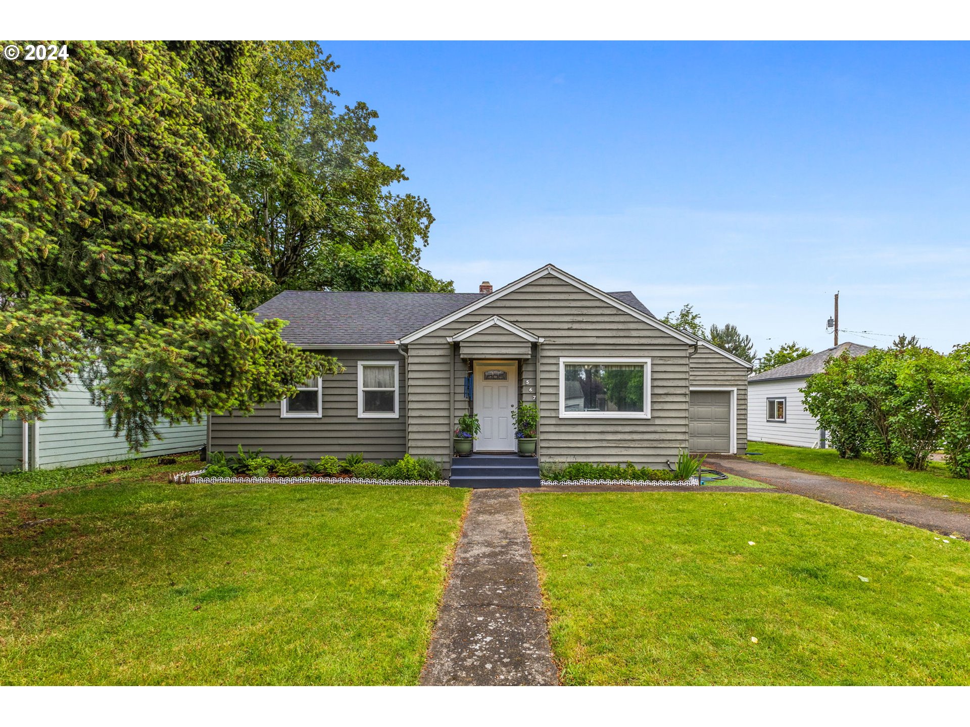 a front view of house with yard and green space