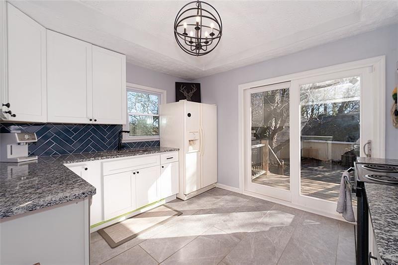 a kitchen with a refrigerator and a stove top oven