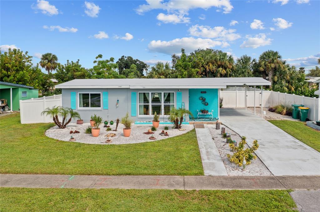 a view of a house with backyard porch and sitting area