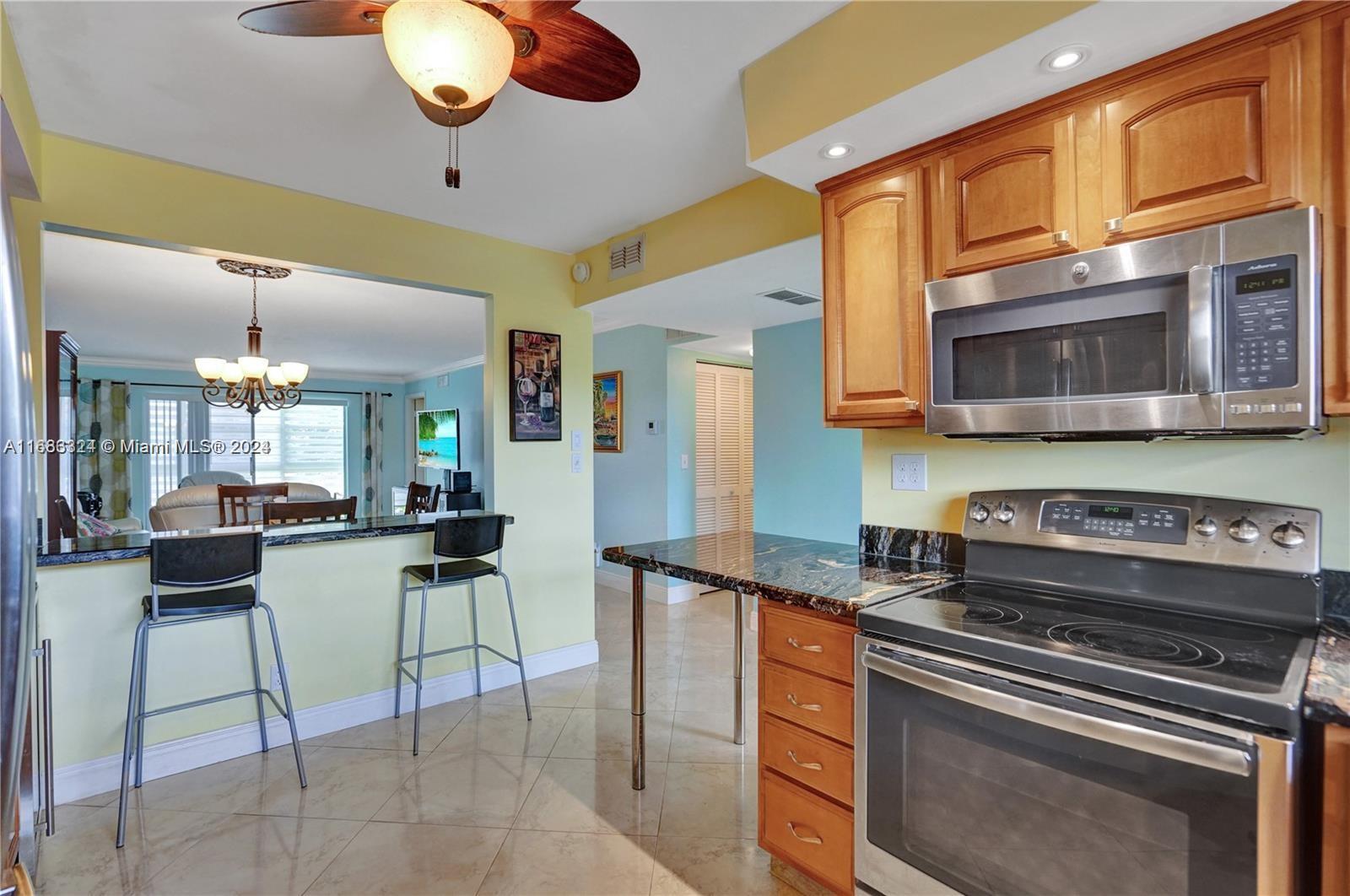 a kitchen with stainless steel appliances granite countertop a stove and cabinets