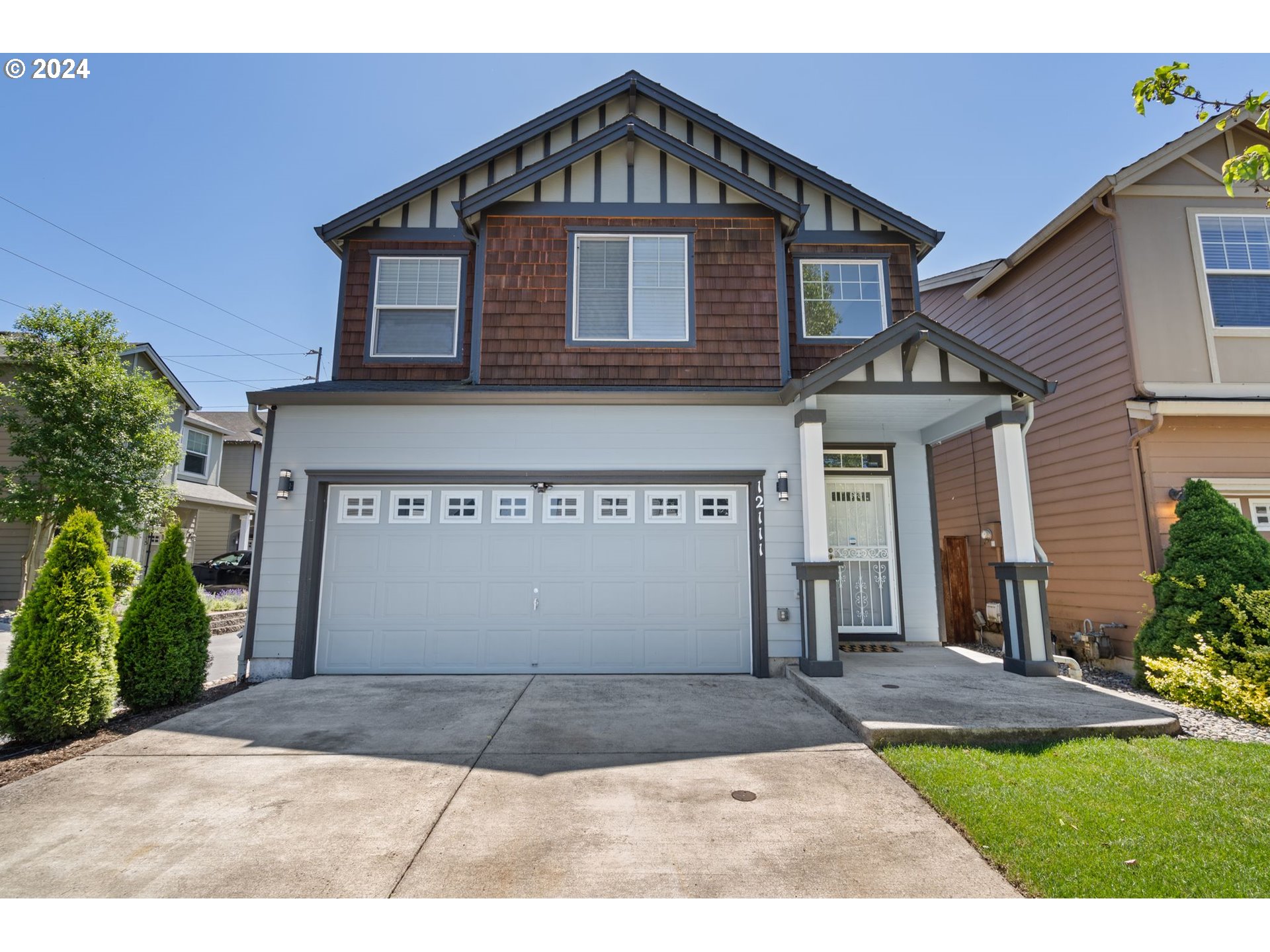 a front view of a house with a yard and garage