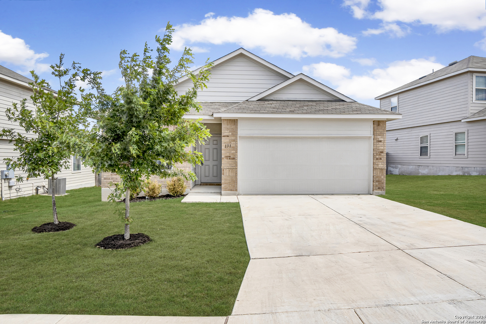 a front view of a house with a yard