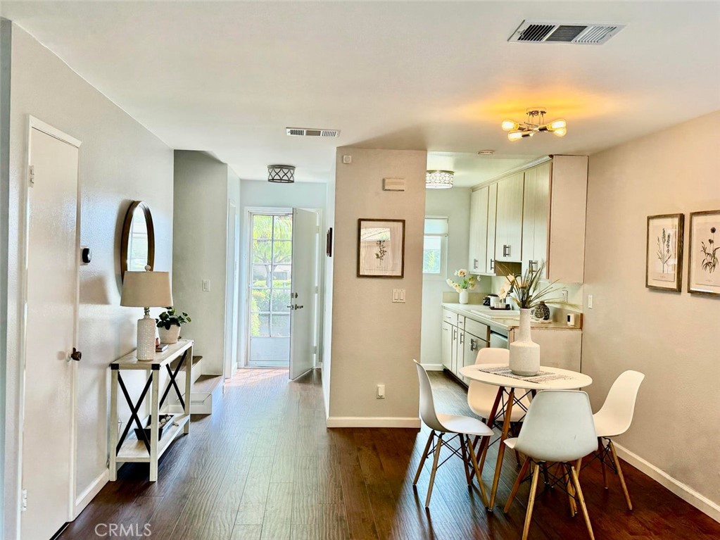 a view of a a dining room with furniture window and wooden floor