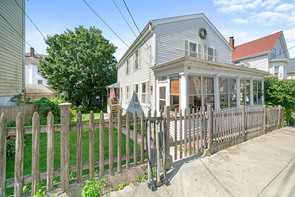 a front view of a house with a garden