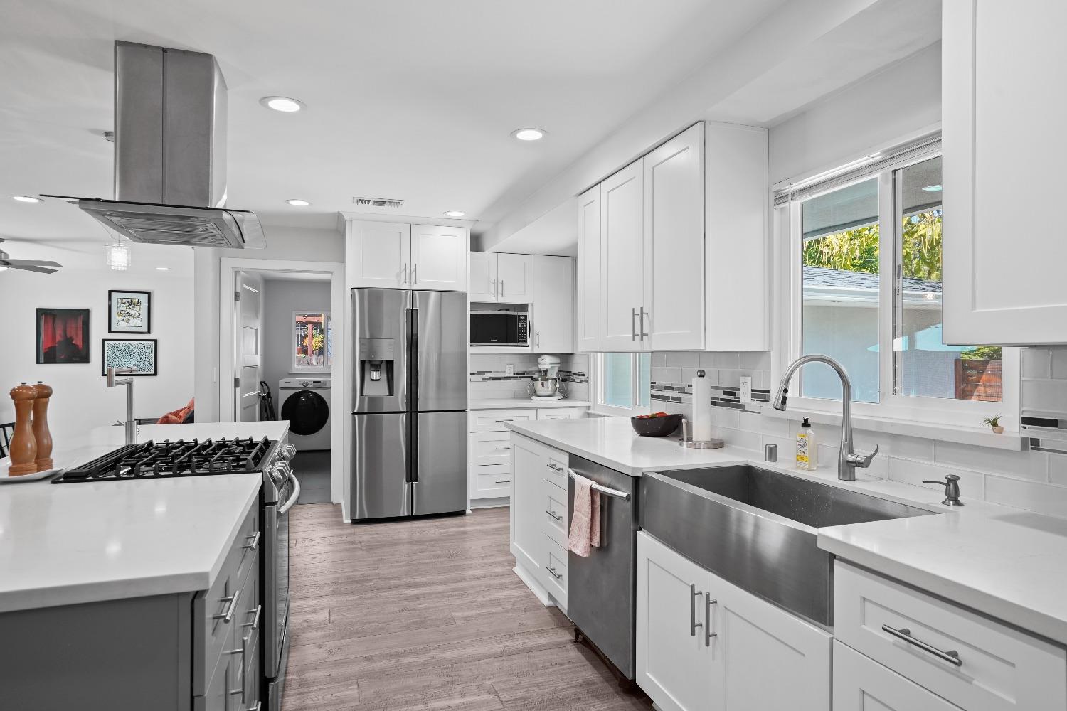 a kitchen with a sink stove and refrigerator