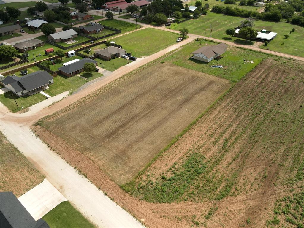 view of a swimming pool with a yard