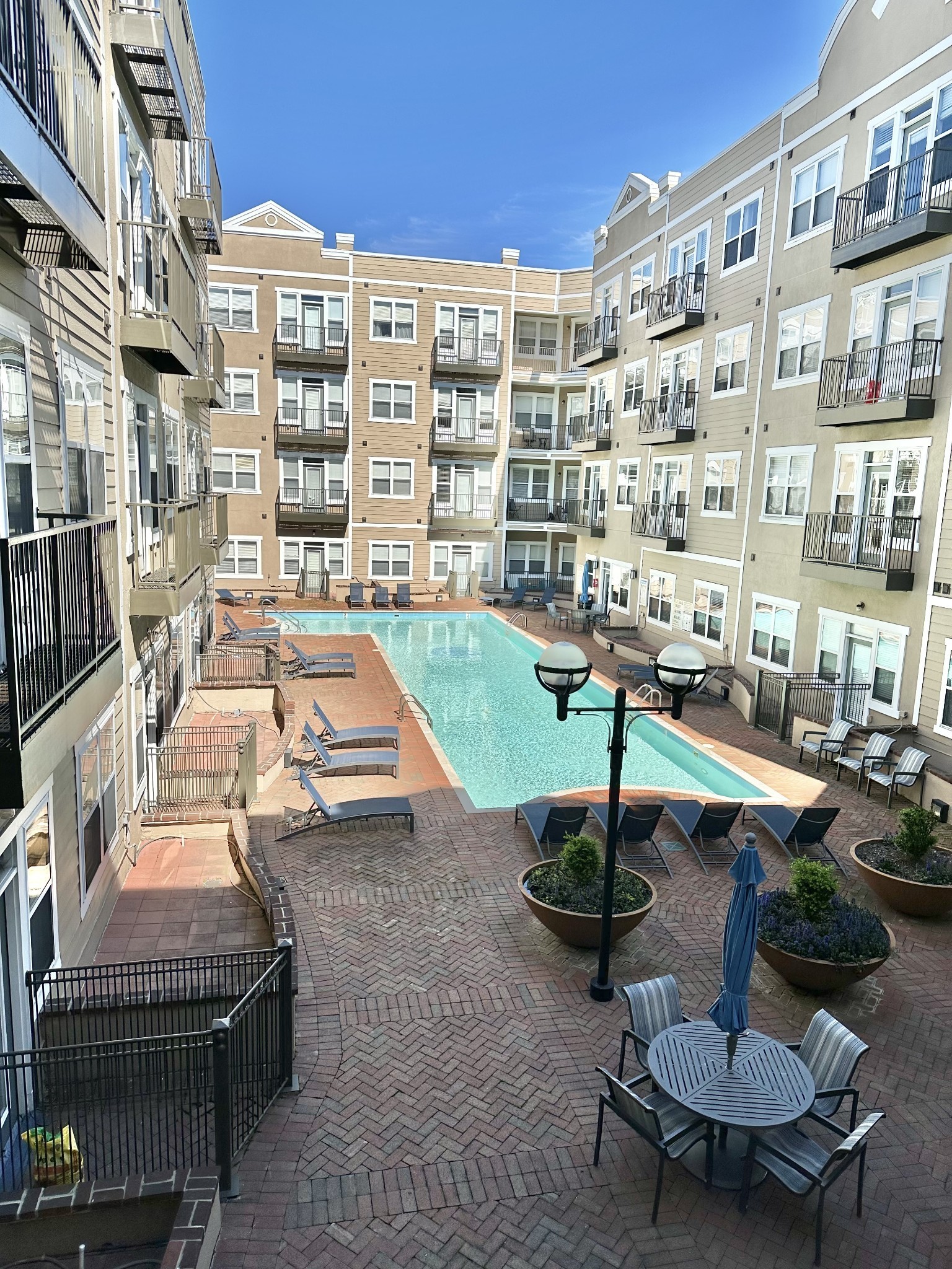 a swimming pool with outdoor seating water view and buildings