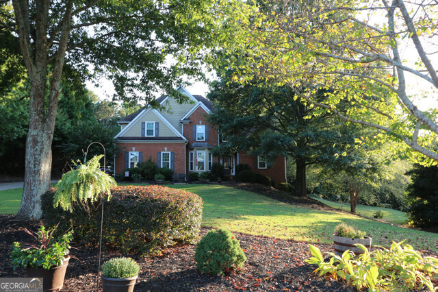 a front view of a house with a yard