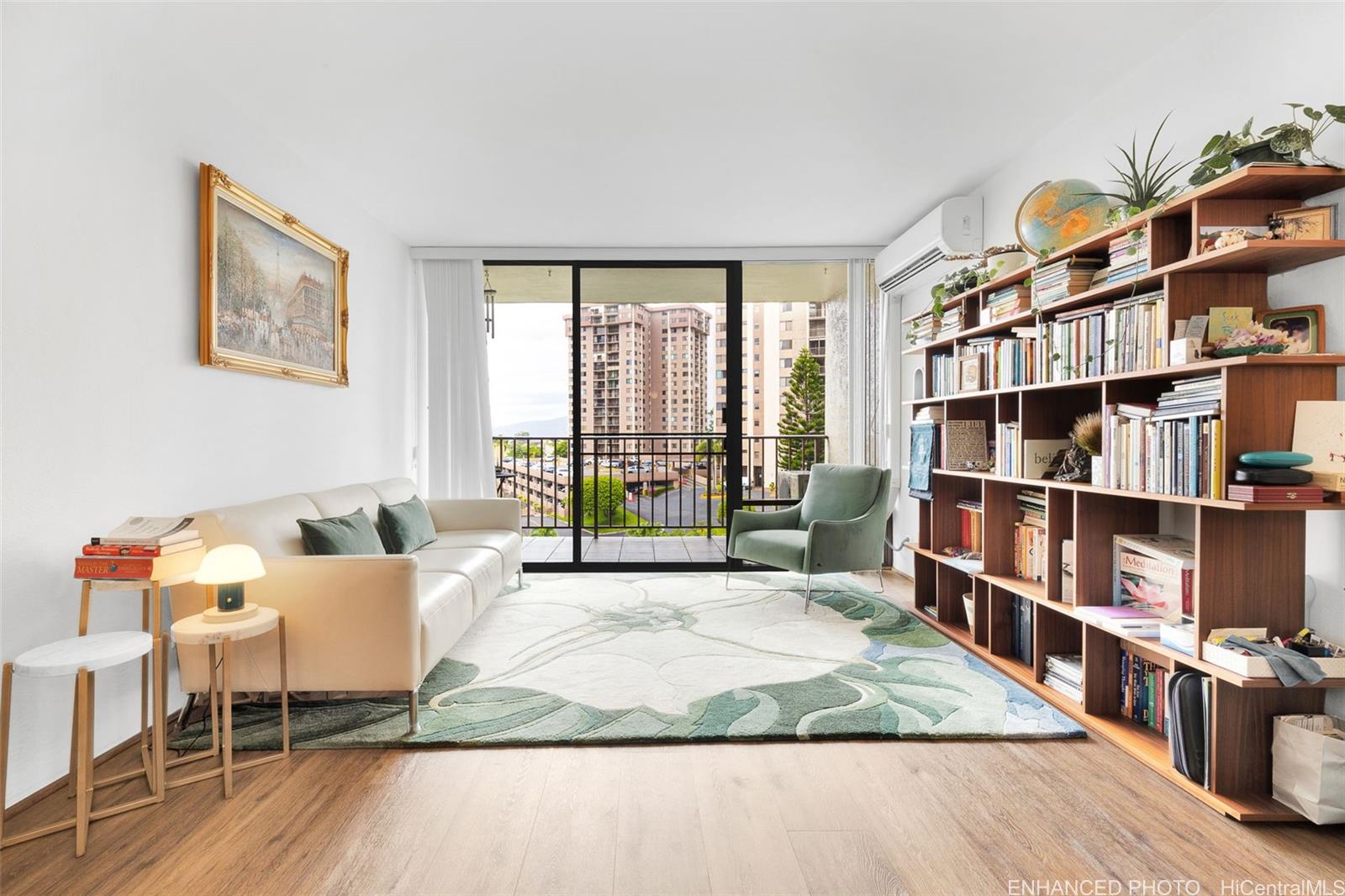 a living room with furniture a rug and a book shelf