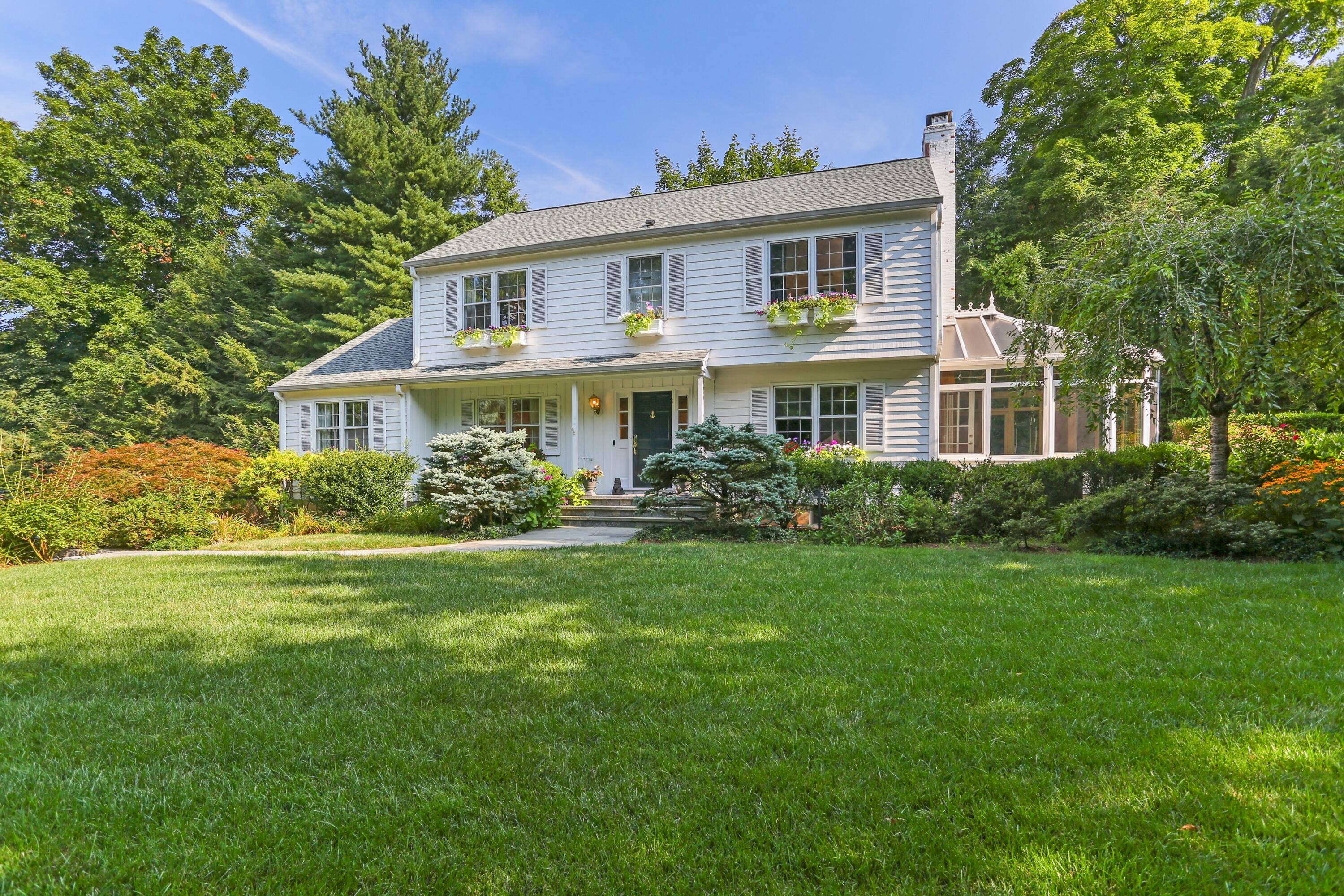 a front view of a house with a garden