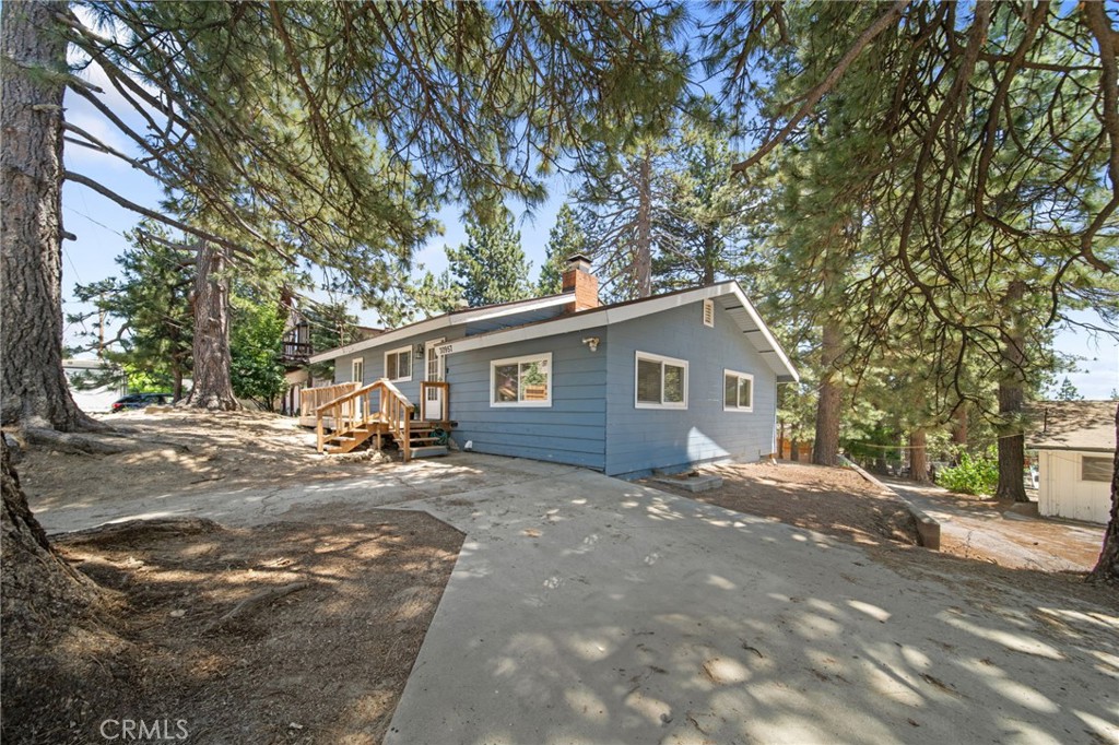 a view of a house with a tree in front of it