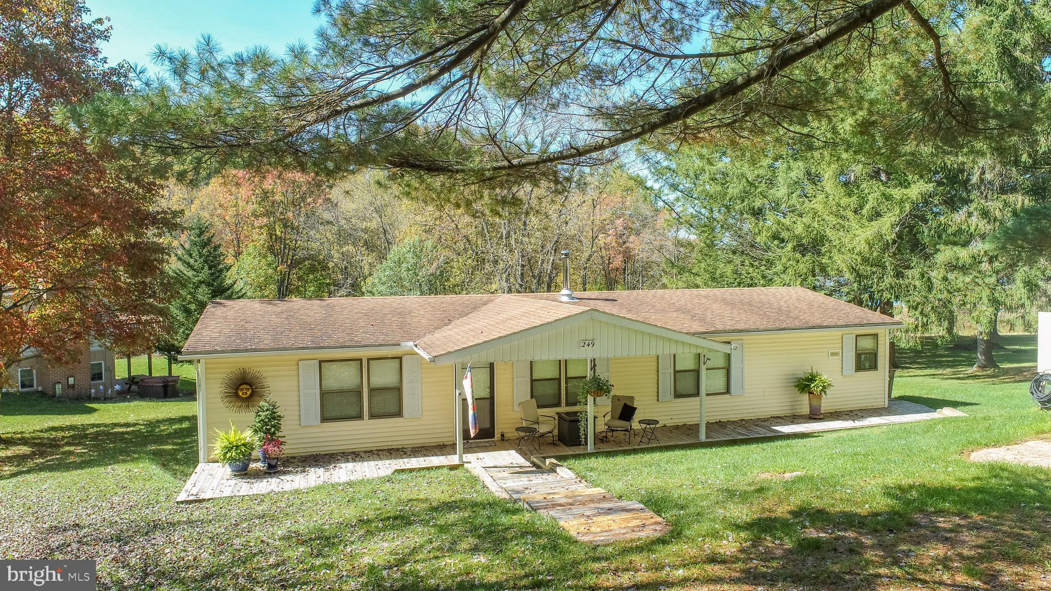 a view of an house with backyard and a tree