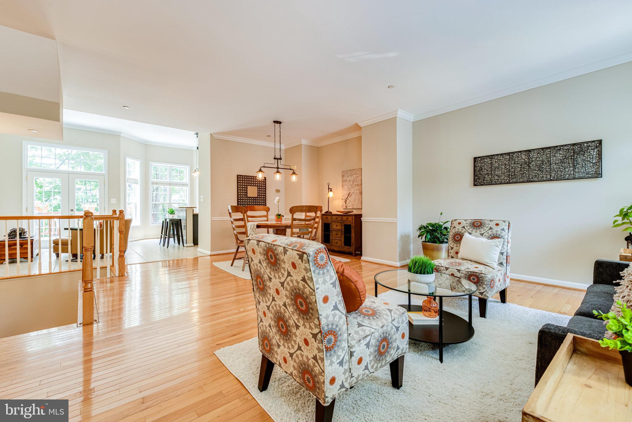 a living room with furniture wooden floor and a table