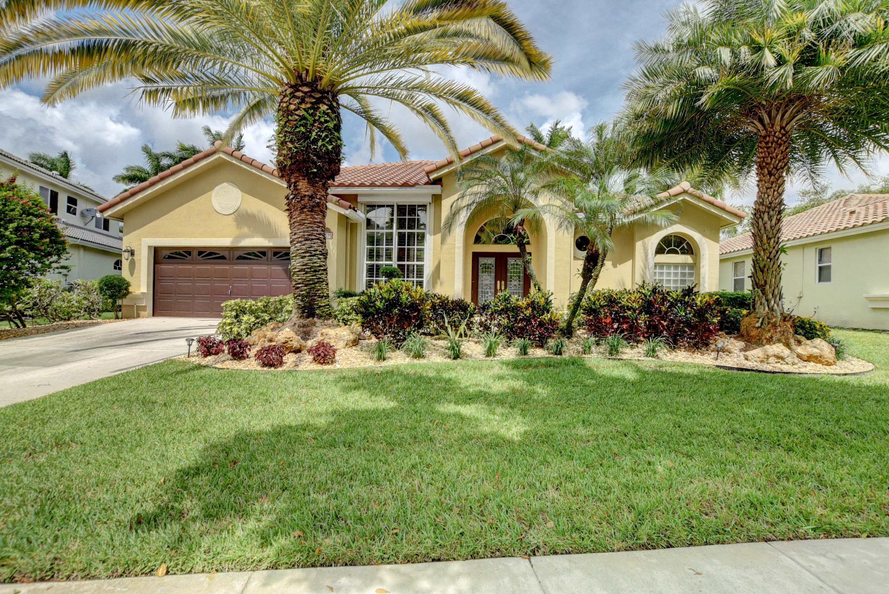 a front view of house with yard and green space