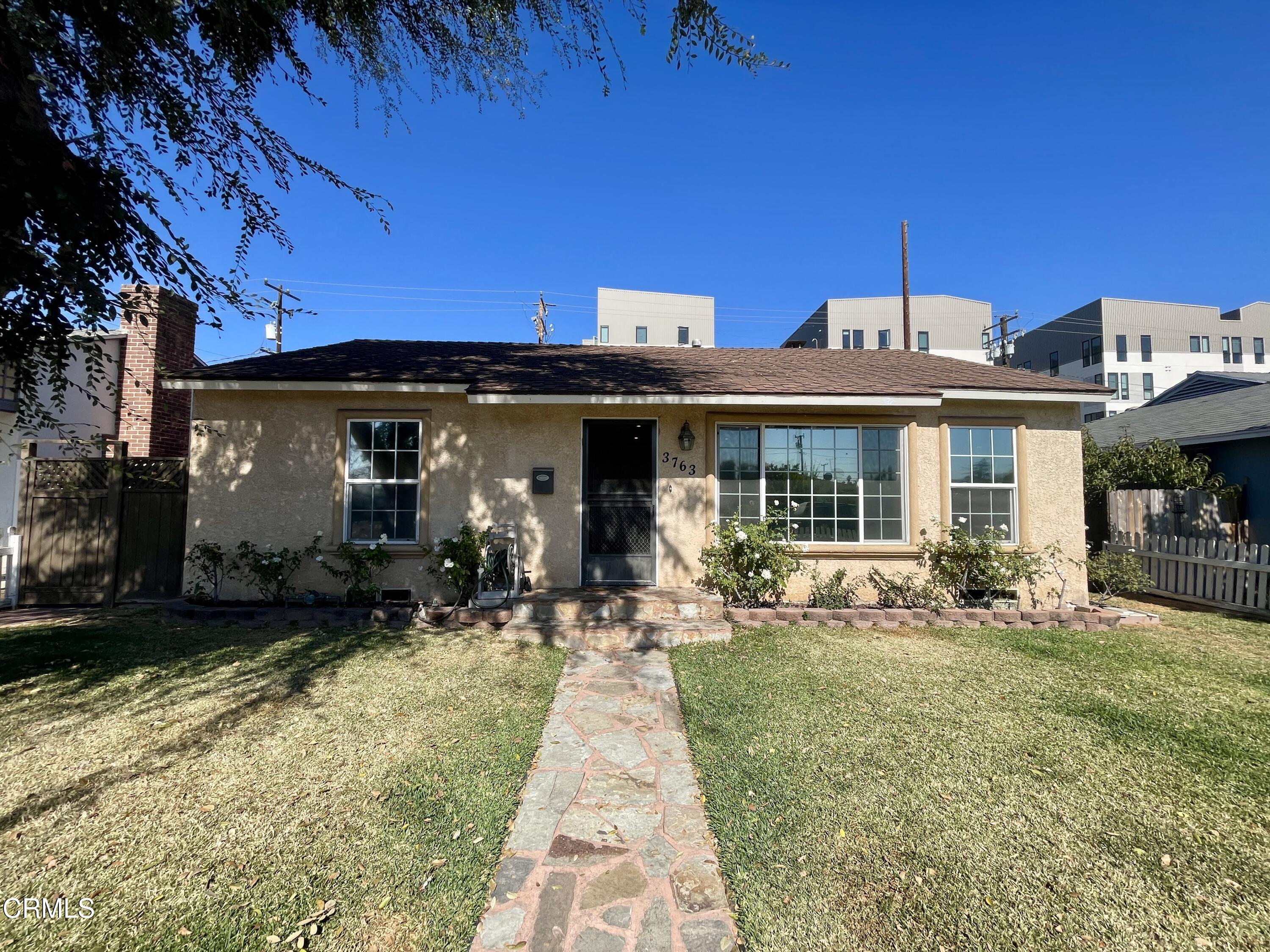 a front view of a house with a garden and patio