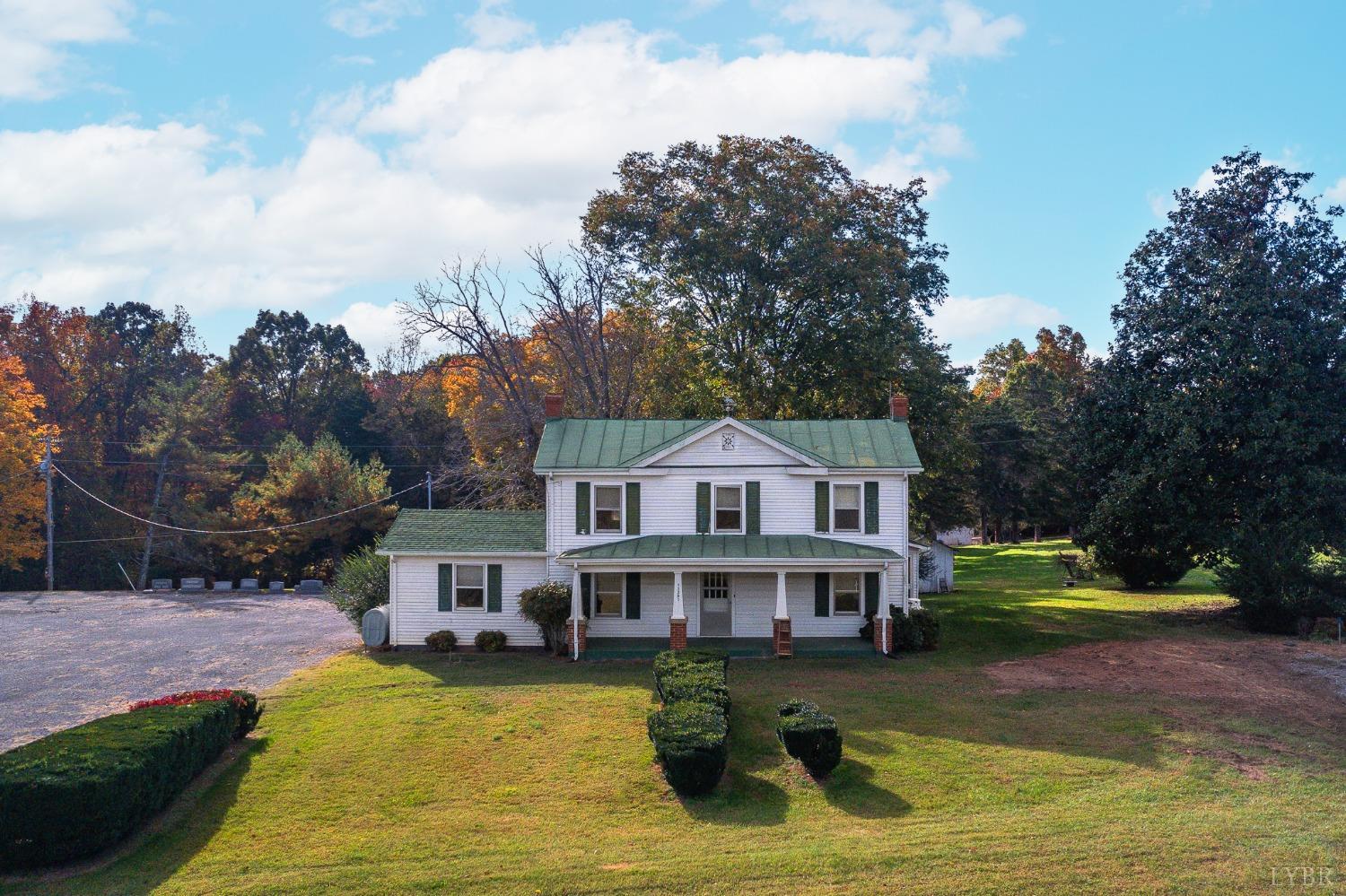 a view of a house with swimming pool next to a yard