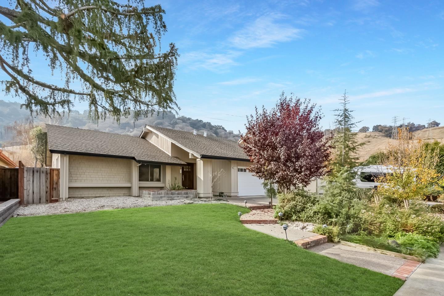 a front view of a house with a garden and yard