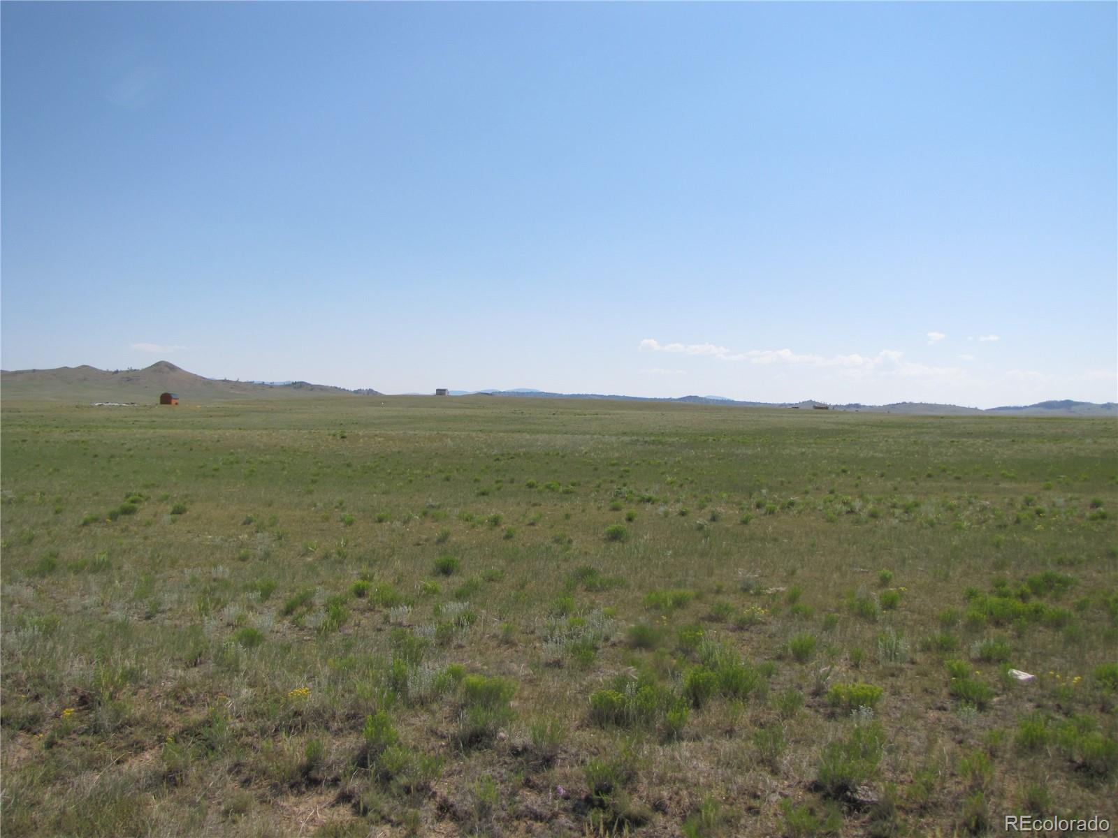 a view of a field with an ocean