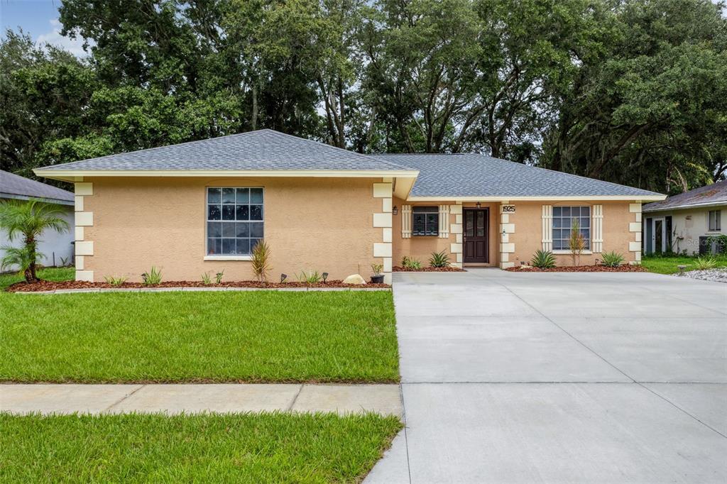 a front view of a house with a garden