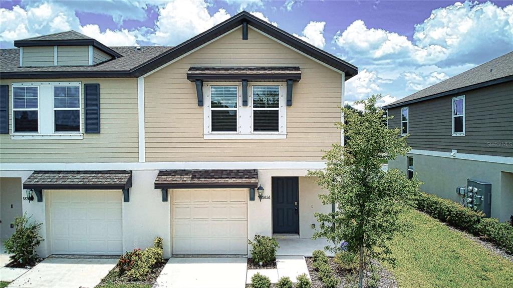 a front view of a house with a garage