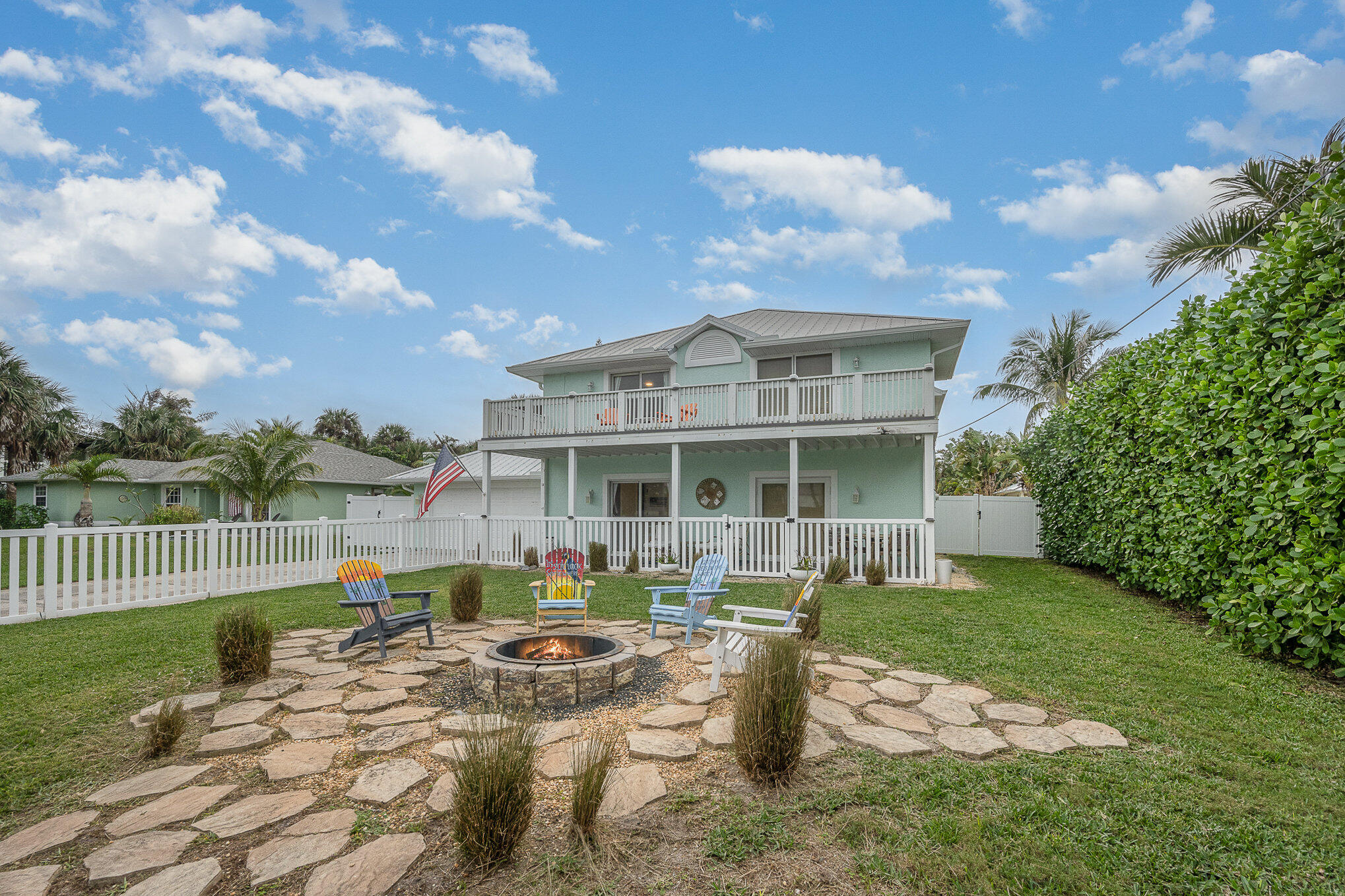 a view of a house with backyard porch and sitting area