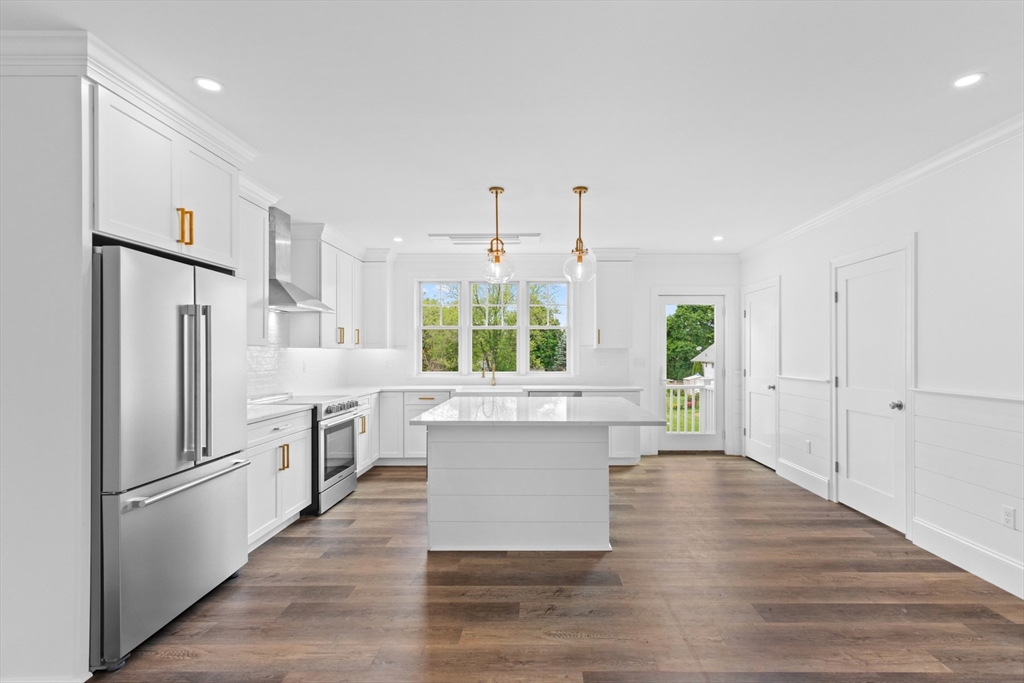 a kitchen with white cabinets and white appliances