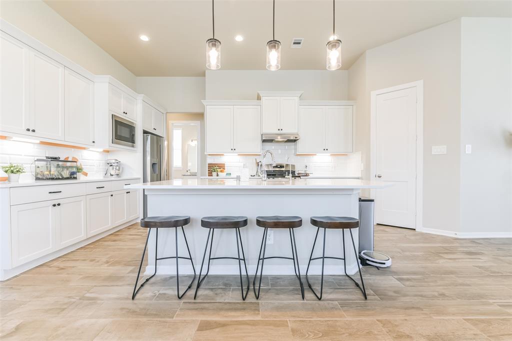 a kitchen with a table and chairs in it