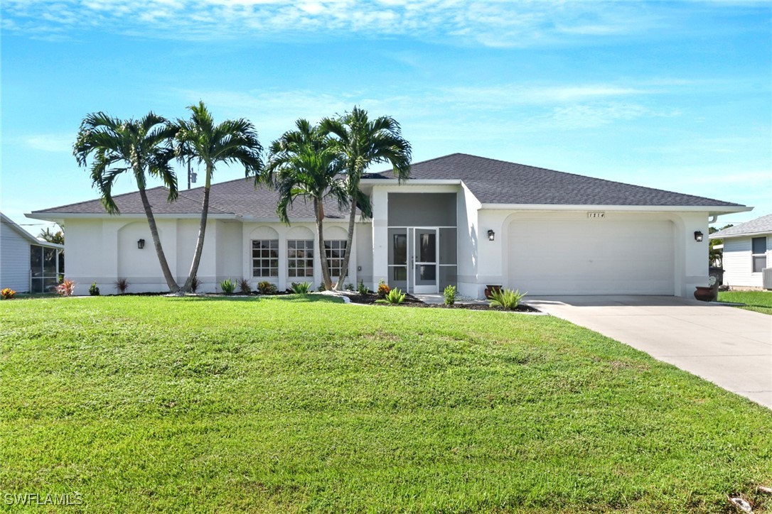 a front view of house with yard and outdoor seating