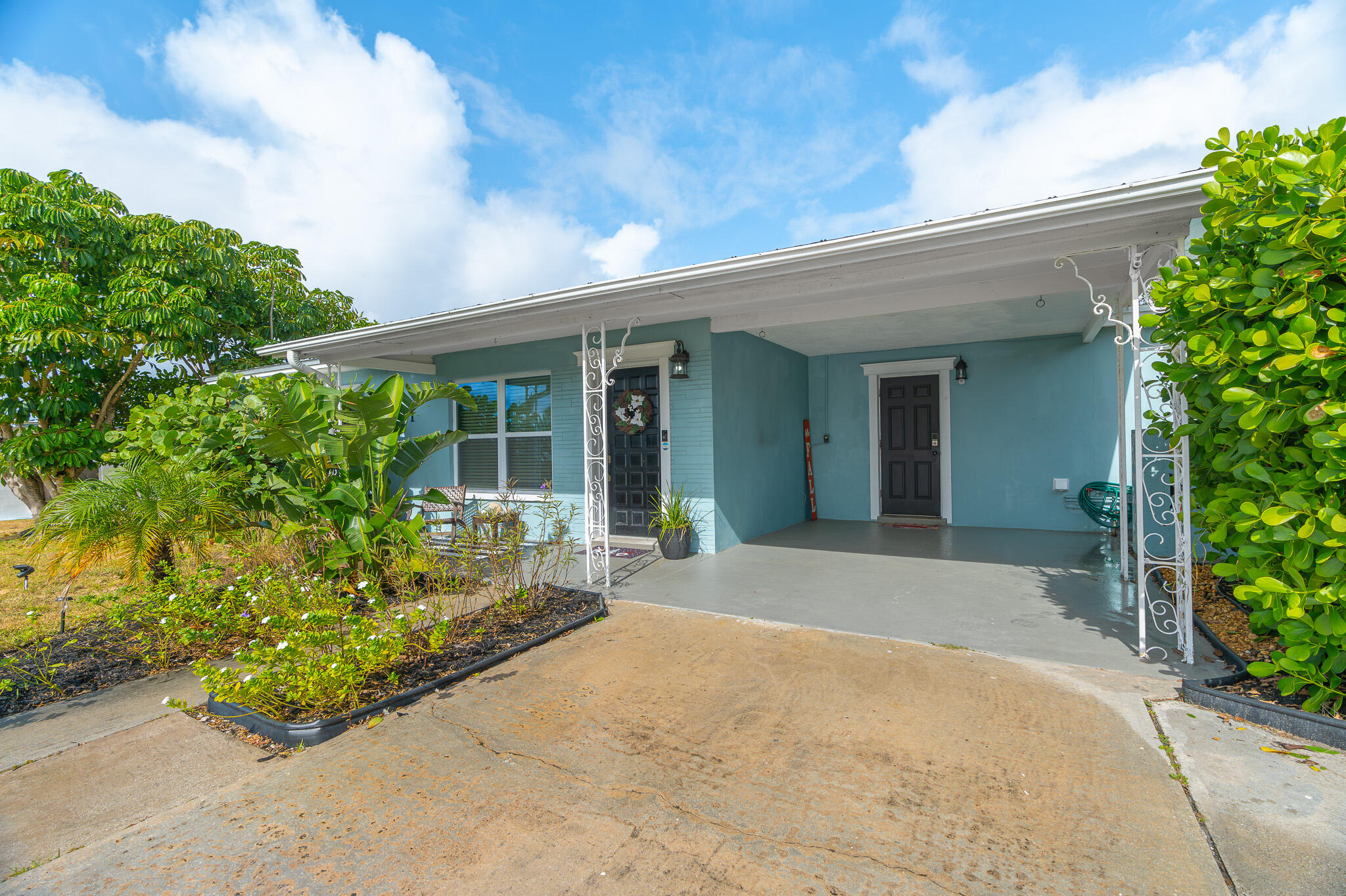 a front view of a house with garden