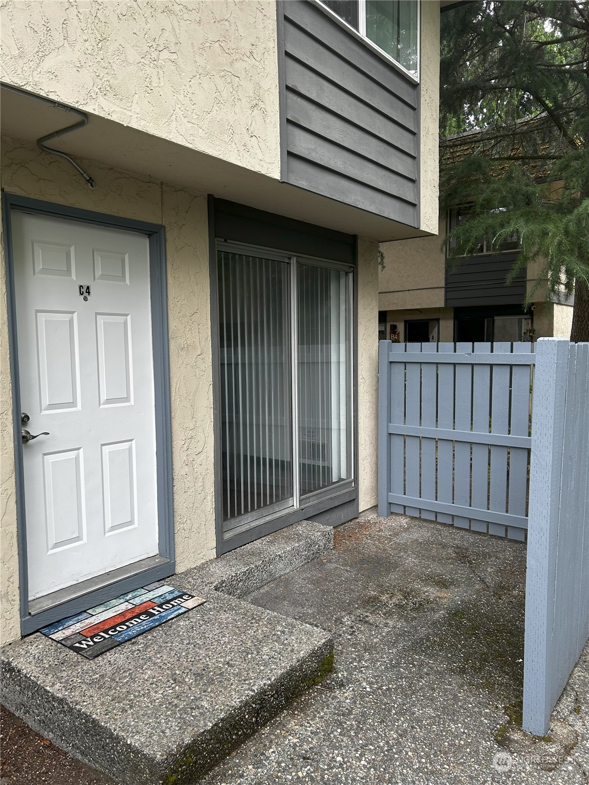 a view of a house with a wooden fence