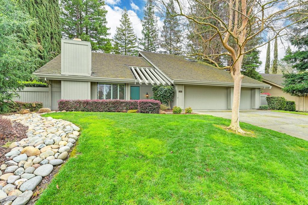 a front view of house with yard and green space