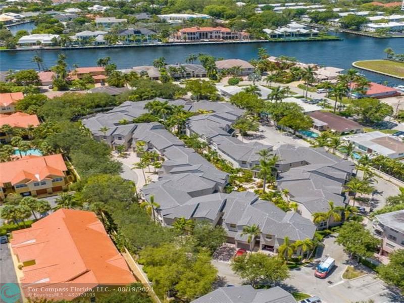 an aerial view of a houses with a lake view