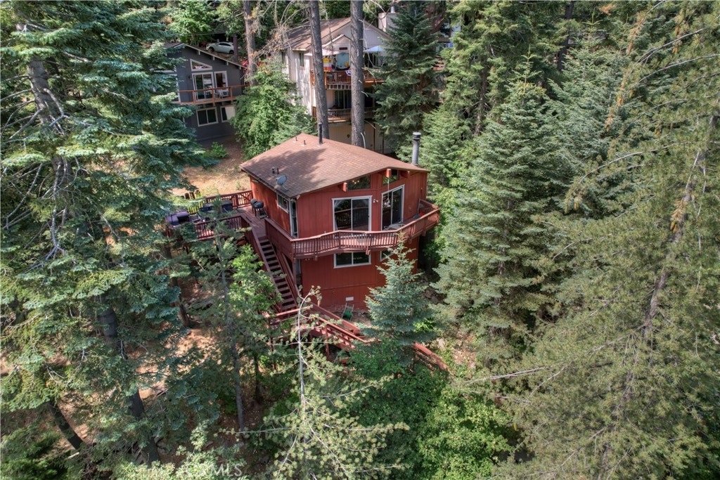 an aerial view of a house with a yard